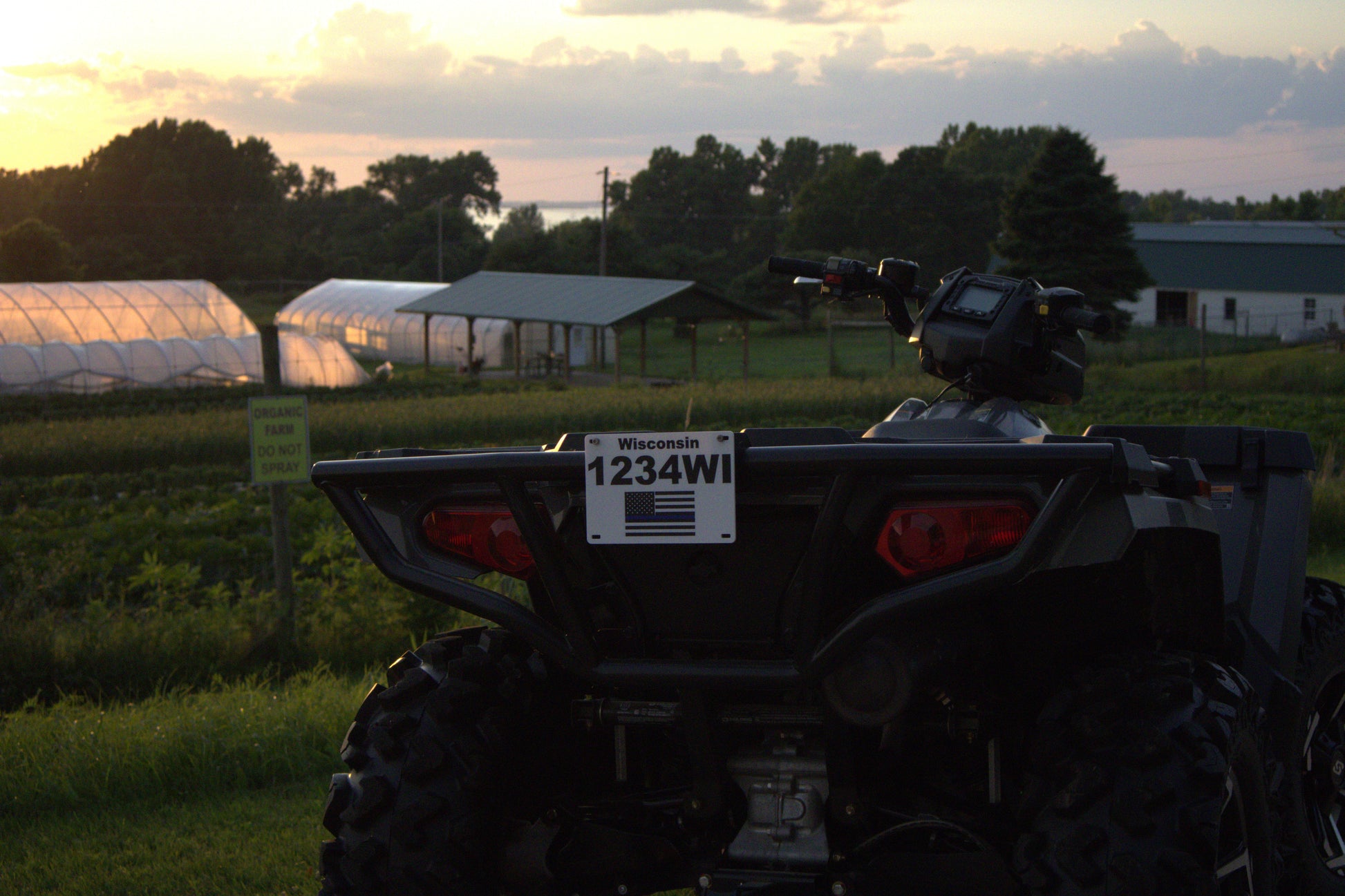 ATV with a license plate in a field during sunset